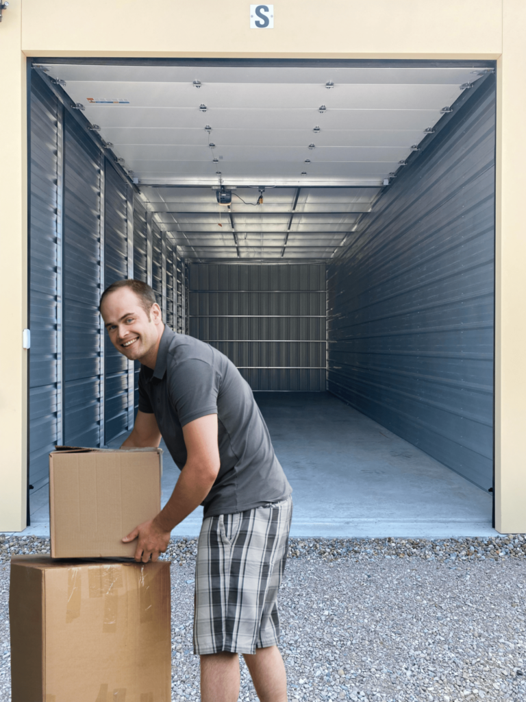 Man Putting Boxes In Storage Units